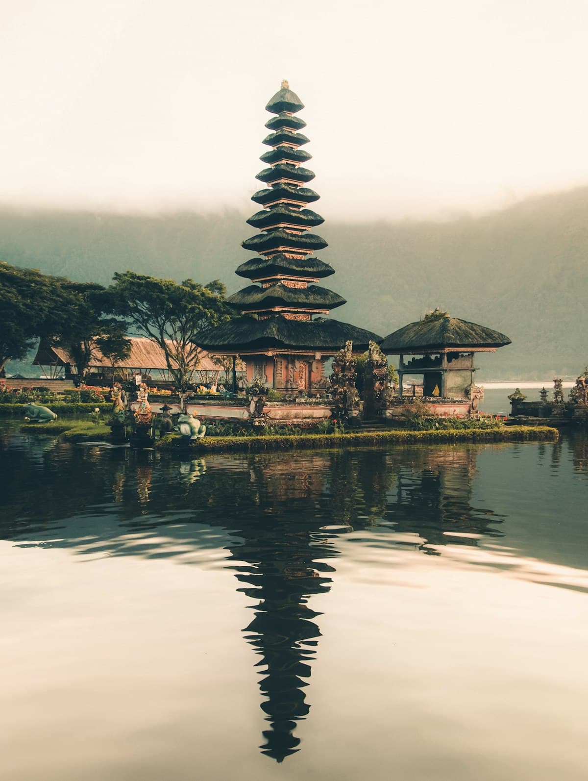 A temple reflected in still water in Bali